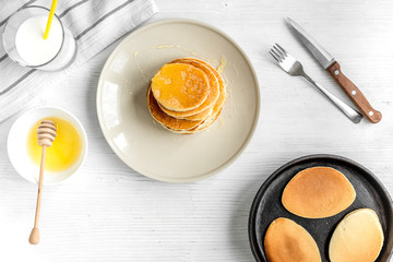 cooked pancake on plate top view at wooden background