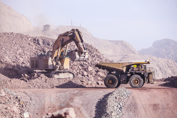 Loading of copper ore on very big dump-body truck