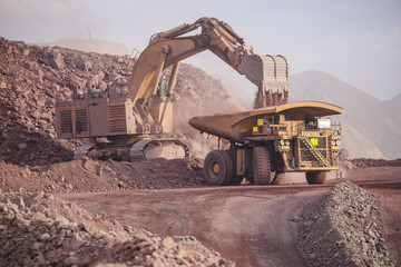 Loading of copper ore on very big dump-body truck
