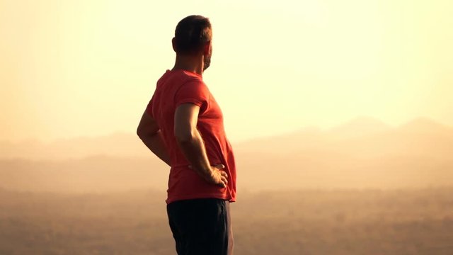 Young man admire sunset and landscape standing on hill, super slow motion 240fps
