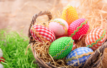 Easter eggs on straw background