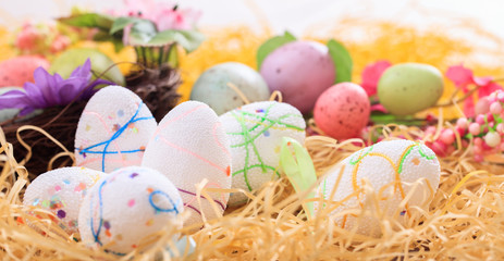 Easter eggs on straw background