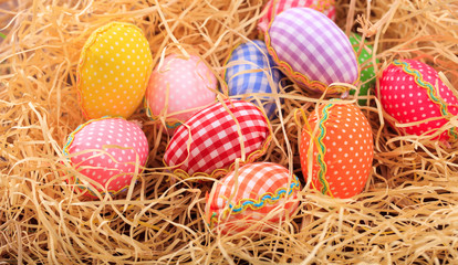 Easter eggs on straw background