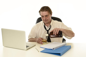 wasted messy alcoholic businessman drinking whiskey working at laptop computer desk at office