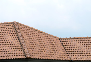 Roof house with tiled roof on blue sky