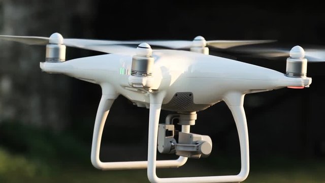 Slow motion video of a white quadcopter drone hovering in an ancient italian town, HD