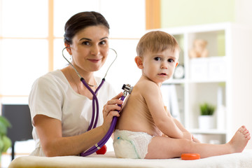 Pediatrician doctor examining kid little child boy
