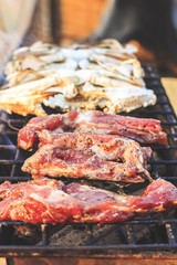 Grill pork rip cooking squid seafood with soft-focus in the background eat restaurant. Over light