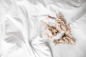 Beautiful silk underwear lingerie lies on a white bed