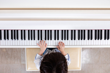 Aerial view of Asian Chinese little boy playing piano