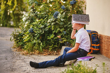 boy with a notebook on the street .The concept of schooling