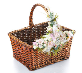 Fototapeta na wymiar basket with flowers to celebrate Easter on a white background