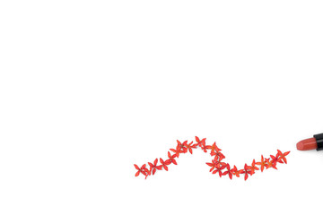 Red lipstick and line of red ixora flowers isolated on white background with copy space