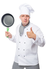 satisfied chef showing thumbs up and holding a frying pan on a white background