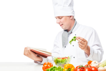 horizontal portrait of the cook at the table with salad and a book of recipes on a white background