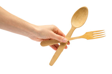 hand of young girl holding spoon and fork.