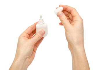 hand of young girl holding nose or eye drops.