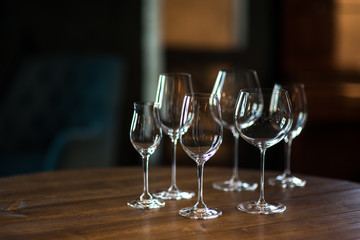 Different types of glasses for wine on wooden table. Still life concept