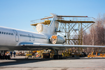 Fototapeta na wymiar Repair and maintenance of passenger aircraft on the aviation technical base