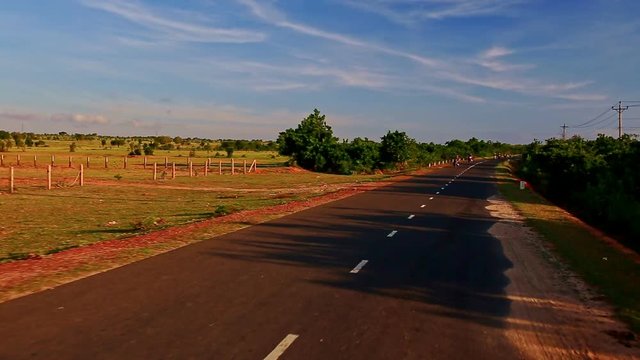 Motion along Plain Road Scooter Traffic by Rural Landscape