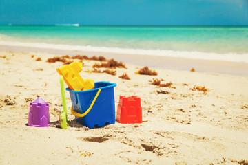 kid toys on tropical sand beach