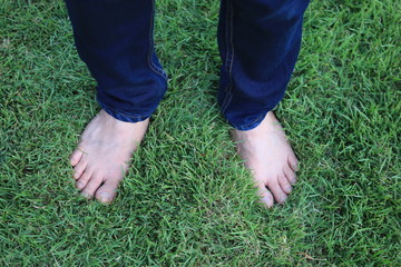 Overhead photo of feets on grass background