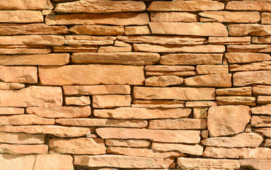 Sand colored stone setting. Stone wall texture.