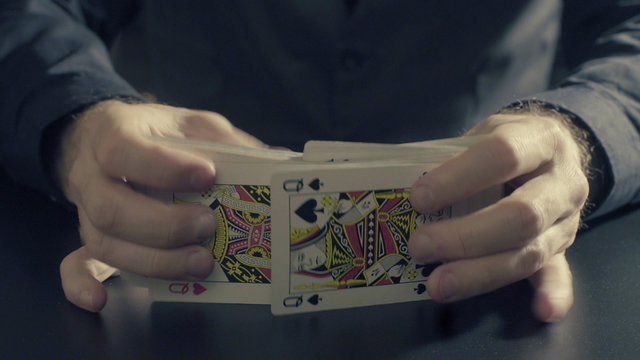 Man's hands shuffing cards. Pocker game