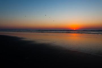 Fototapeta premium Sundown on the Washington coast with a reflective beach