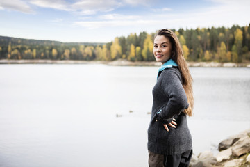 Beautiful Young Woman Standing By Lake