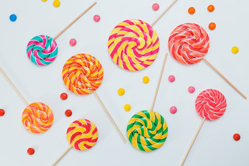 Pattern sweet lollipops, candy on white background, top view flat lay.