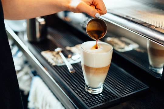 Close-up of barista preparing caffe latte