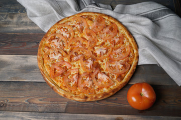 Served pizza with tomatoes