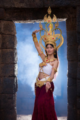 Asian woman wearing cambodia traditional dress in stone wall