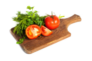 Red tomatoes with parsley on a wooden board
