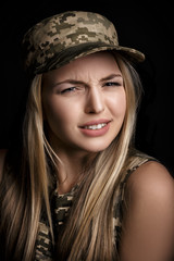 portrait of beautiful woman soldiers in military attire on black background