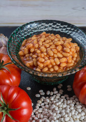 Traditional English food - baked white beans in tomato sauce and ingredients ready to cook