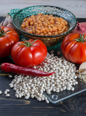 Traditional English food - baked white beans in tomato sauce and ingredients ready to cook