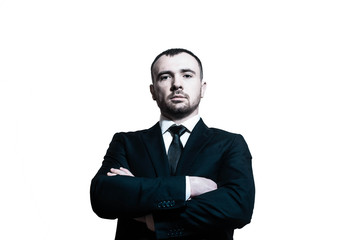 Serious determined handsome young businessman / ceo / banker / lawyer / angry boss / ceo with hands crossed in a business suit on a white background one man only
