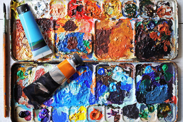 paintbrush palette on the wooden floor.
