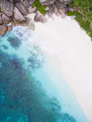Seychelles Island white tropical paradise beach, turquoise sea and granite rocks aerial landscape. La Digue Grand Anse beach seascape. 