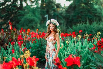 Beautiful young girl in a floral park. flower Fairy