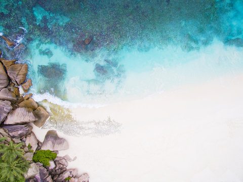 Seychelles Island white tropical paradise beach, turquoise sea and granite rocks aerial landscape. La Digue Grand Anse beach seascape. 