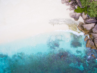 Seychelles Island white tropical paradise beach, turquoise sea and granite rocks aerial landscape. La Digue Grand Anse beach seascape. 
