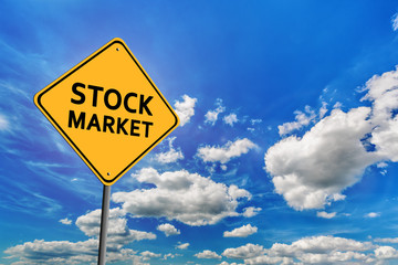 Blue cloudy sky and yellow road sign