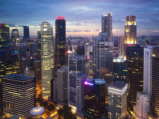 Modern skyscrapers urban city Singapore buildings lit up evening night cityscape 