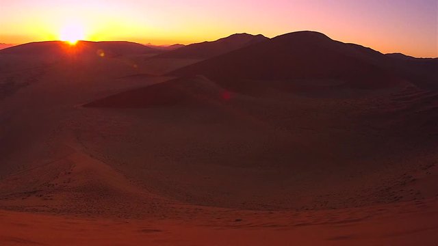 Sunrise time-lapse of largest sand dunes in the world in Namib Desert, Namibia, Africa. Recorded atop famous Dune 45 near Sossusvlei. Standing over 170 m, it's composed of 5-million-year-old sand. 4K.