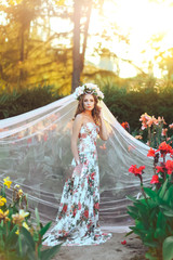 Fototapeta premium Beautiful young girl in a floral park. flower Fairy