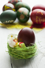 Easter eggs and white wooden country table, background and texture