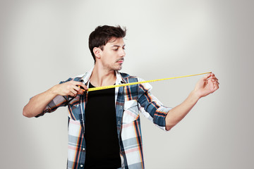 young man holding measurement tape
